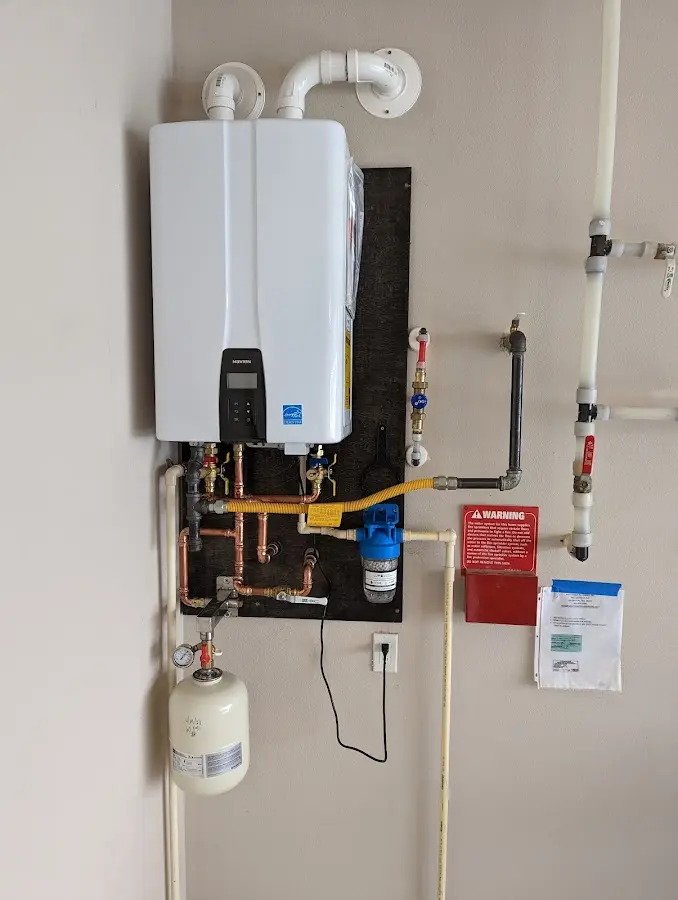 Professional plumber installing copper piping in a Tewksbury home